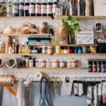 Modern smart wall storage solutions featuring a wall-mounted desk and pegboard in a studio apartment.