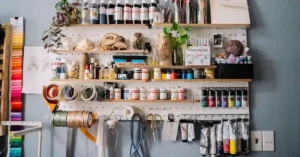 Modern smart wall storage solutions featuring a wall-mounted desk and pegboard in a studio apartment.