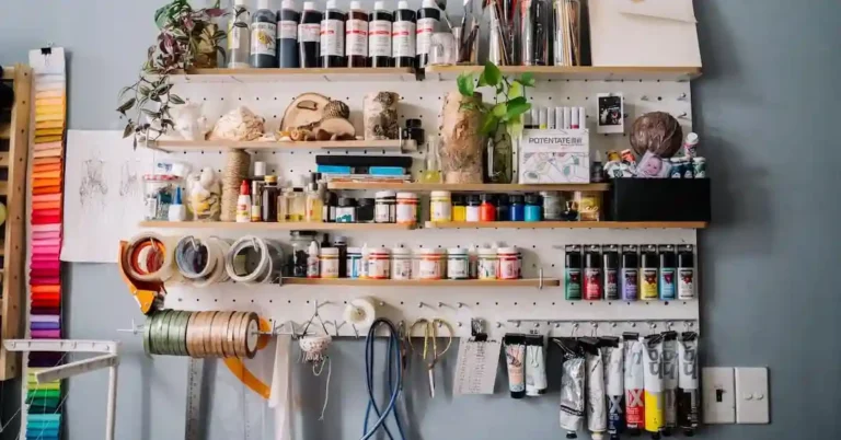 Modern smart wall storage solutions featuring a wall-mounted desk and pegboard in a studio apartment.