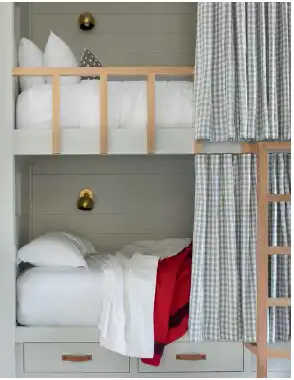 Full-size bunk bed solutions featuring checked privacy curtains on tracks, designed by Brittany Haines for a Tahoe retreat.