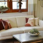 Strategic **space optimization** in a modern living room, replacing bulky traditional furniture with sleek minimalist 2026 designs while maintaining room authenticity.